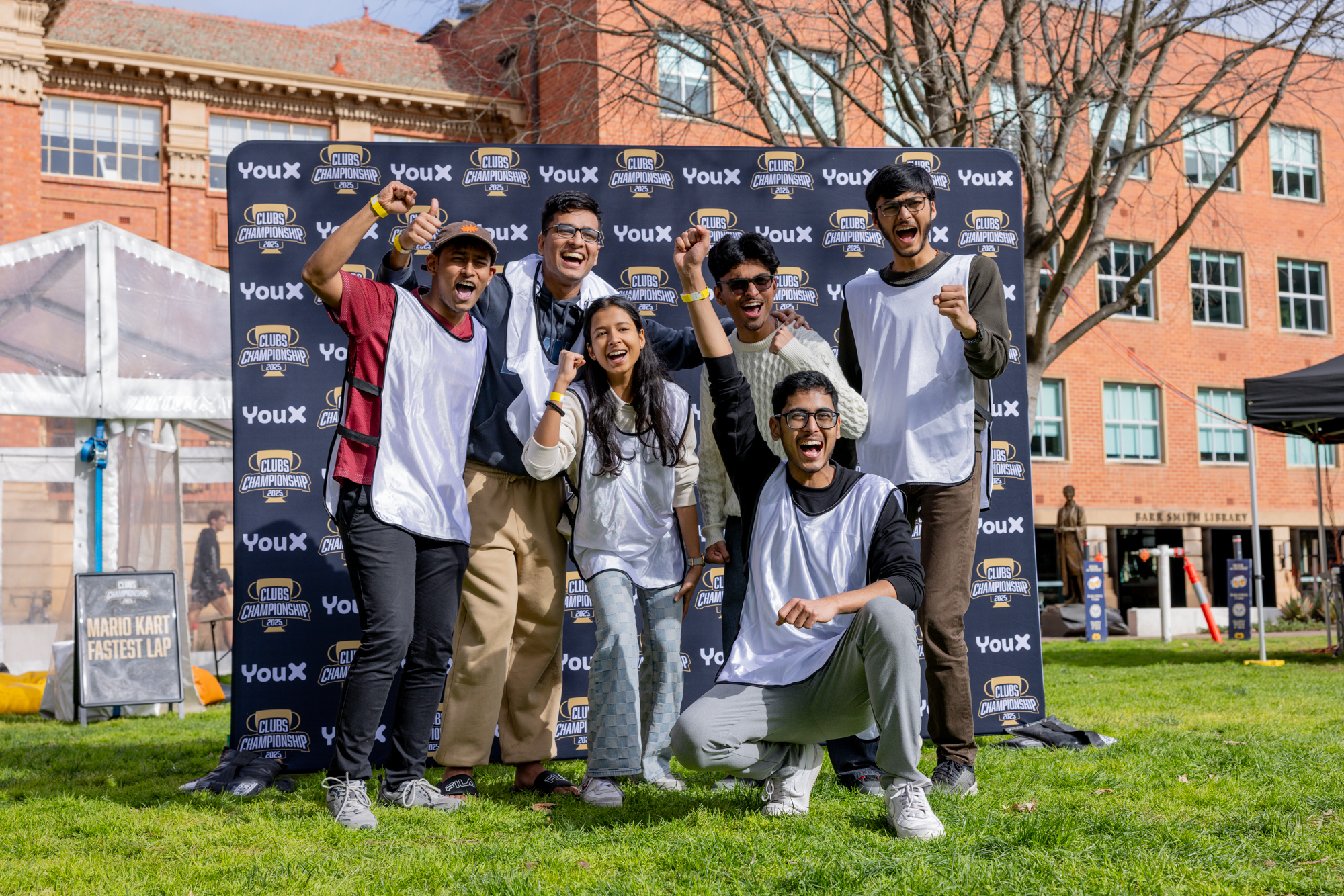 Semi Colon from AI and ML Club raising their fists at the Barr Smith Lawns after winning the Clubs Championship